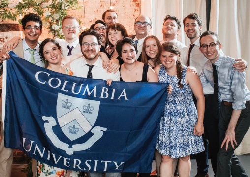 a wedding party with a Columbia banner