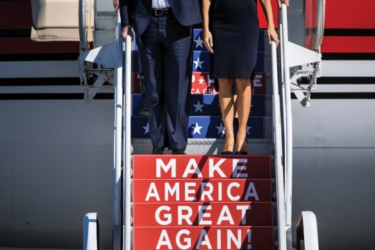 A photograph of Donald and Melania Trump as they descend from their private jet at Wilmington International Airport, Wilmington, N.C.; November 5, 2016.