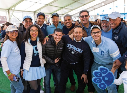 Several people smiling at Columbia's 75th Homecoming game.