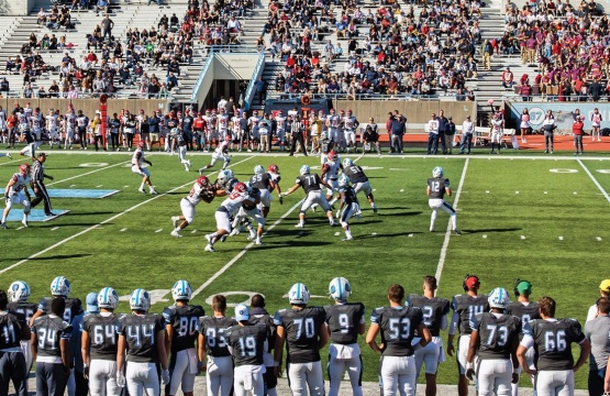 Columbia Lions football players on the field playing against University of Pennsylvania Quakers