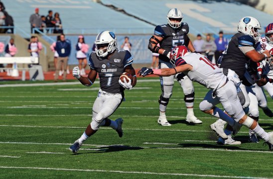 Columbia Lions football player number 7 running with the ball away from the opposing team