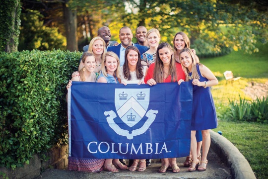 wedding party with Columbia banner