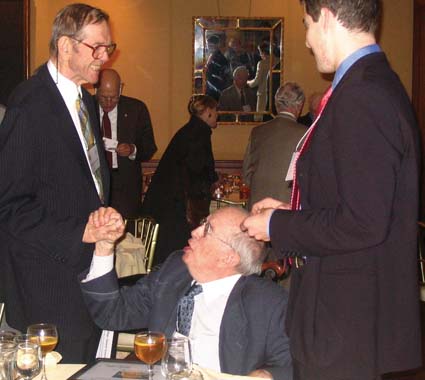 Robert Clayton ’48 (middle, left) greets Joe Coffee ’41 (center)