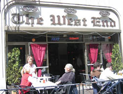 Customers enjoy the West End's sidewalk seating on a sunny April day just prior to the sale.