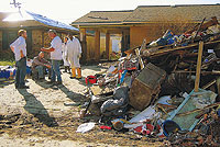 Photo of volunteers outside a gutted house