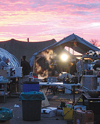 Photo of volunteers cooking in tents