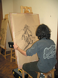A young artist works on a drawing