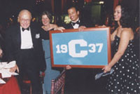 Kluge accepts a framed class banner