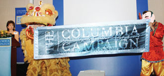 The Hong Kong version of the Columbia Lion and a friend hold the launch banner