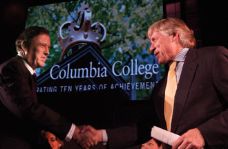 President Lee Bollinger (right) congratulates Dean Austin Quigley