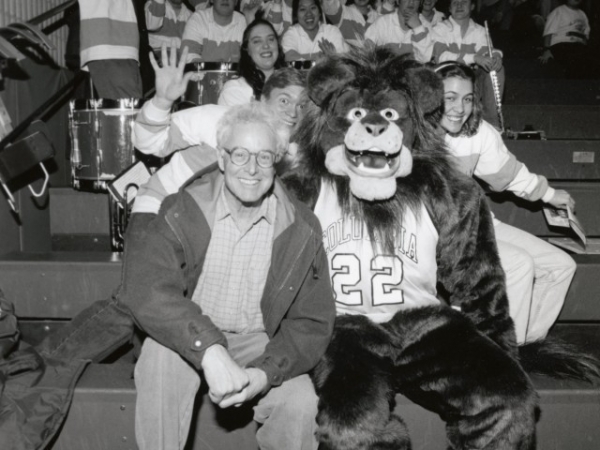 Photo of Robert Berne CC’60, BUS’62 in 2000 with the Lion mascot in the new Lion costume Berne donated
