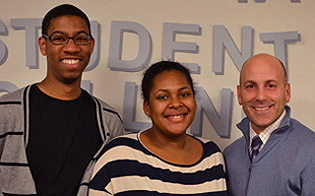 Annual fund student callers Brandon Lewis ’13 and Diane Jean-Mary ’13, pictured here with Jeff Richard, v.p. for University development, each raised $100,000 in pledges.